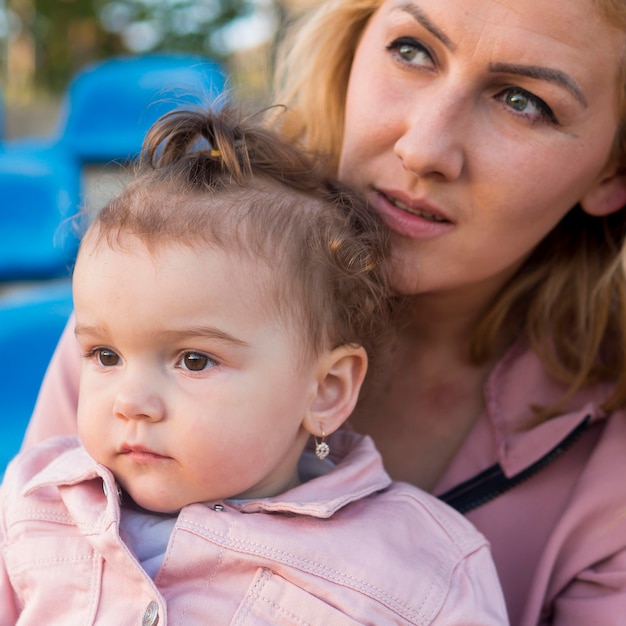 Child in pink clothes and mother portrait