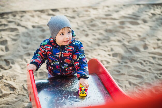 Child playing outside on slide