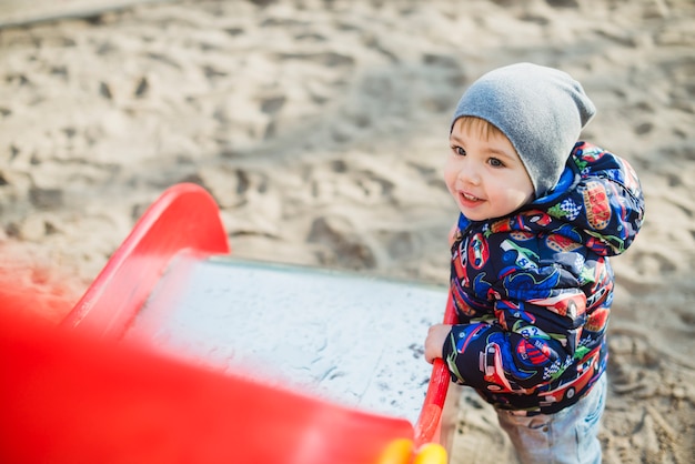 Free photo child playing outside on slide