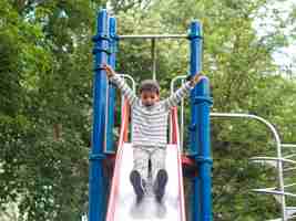 Free photo child playing in the park low view