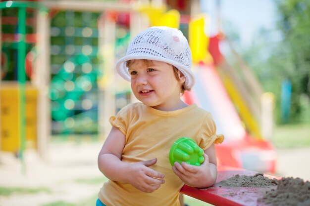 child playing  in sandbox