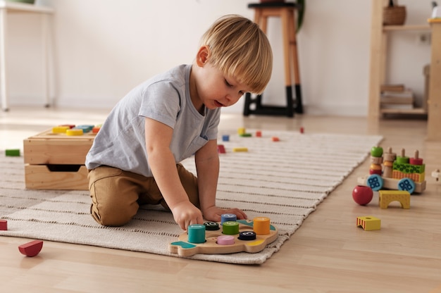 Child playing with colorful toys full shot