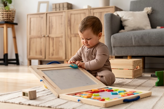 Bambino che gioca con i giocattoli colorati a tutto campo