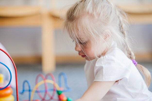 Free photo child in playroom of kindergarten