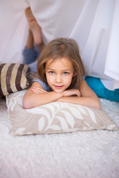 Child resting on comfortable pillows