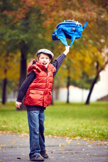 Child throwing his backpack