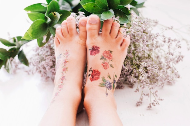 Free photo child touching flowers with feet