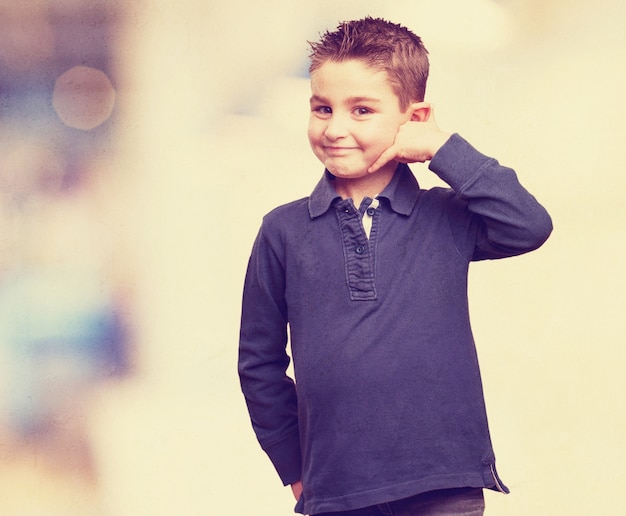 Child using a phone with his hand