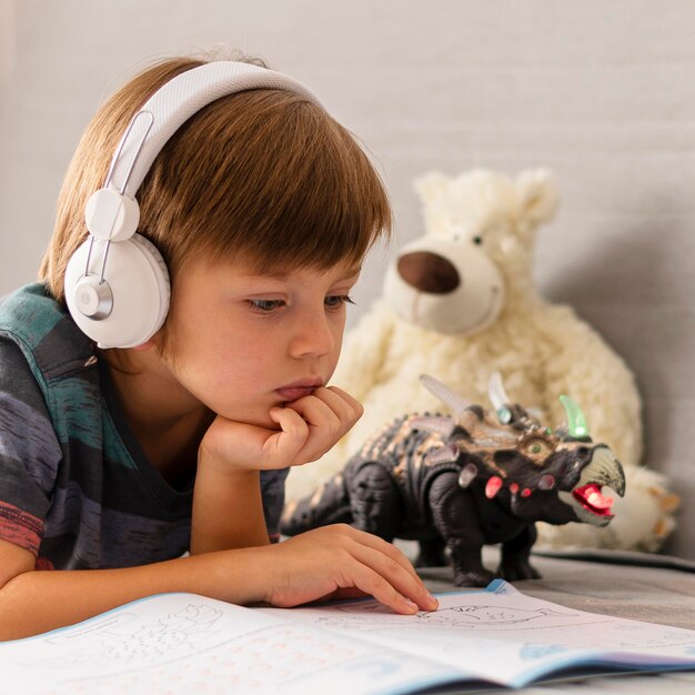 Child wearing headphones attending online school