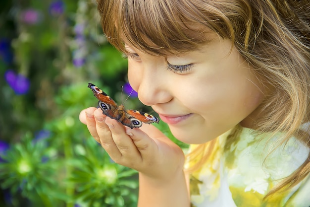 Premium Photo | Child with a butterfly in her hands.