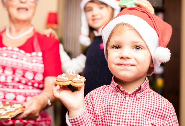 Child with christmas cookies his grandmother