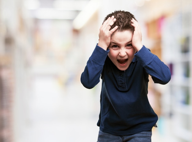 Child with hands on head