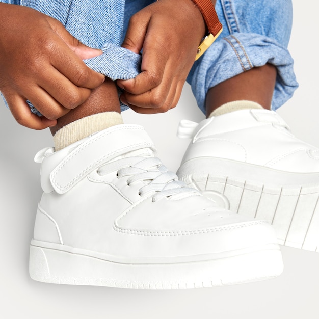 Child with jeans white sneakers