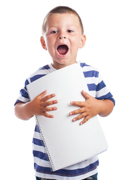 Child with open mouth and blank notepad