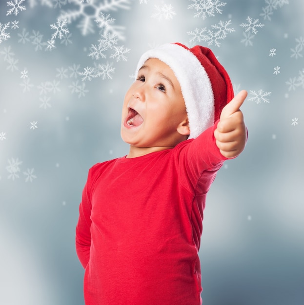 Child with open mouth in snow background