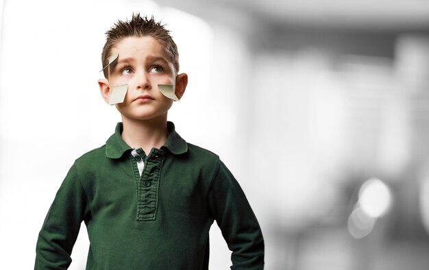 Child with post-it in the face