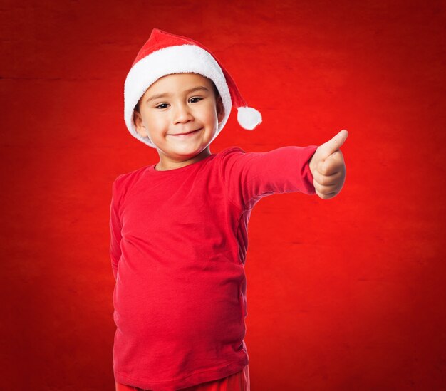 Child with thumb up and red background