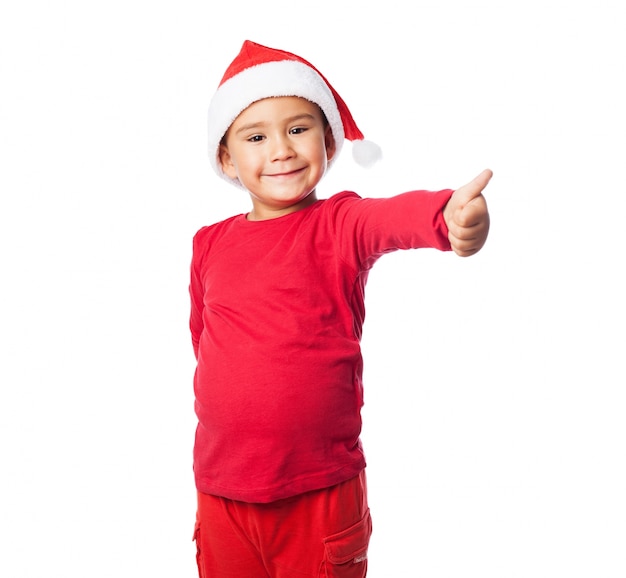 Child with thumb up and red dress