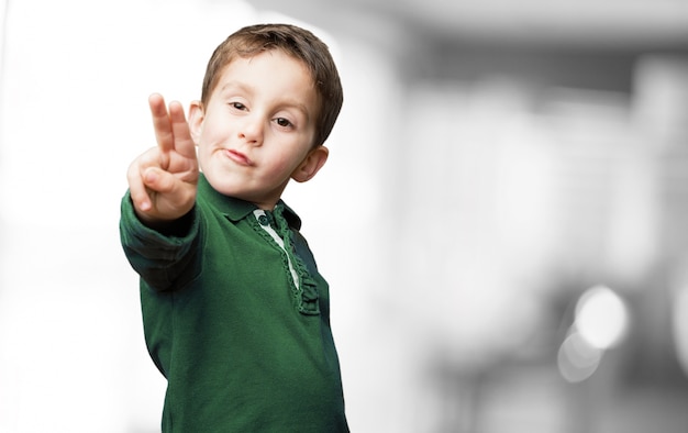 Free photo child with two raised fingers