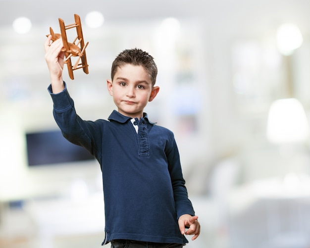 Free photo child with a wooden plane