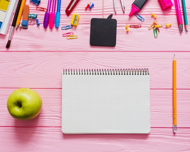 Free photo childish notebook, pencil and apple