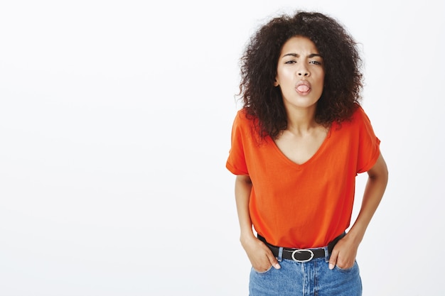 childish woman with afro hairstyle posing in the studio