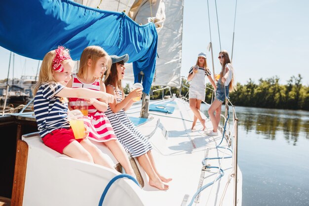 The children on board of sea yacht