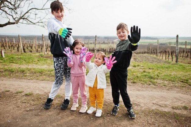 Free photo children cleaning in the vineyards show their gloves environmental conservation and ecology recycling