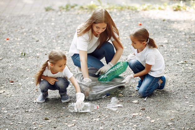 Children collects garbage in garbage bags in park