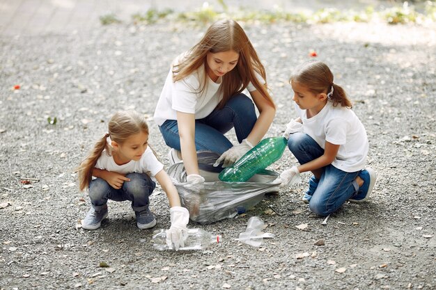 Children collects garbage in garbage bags in park