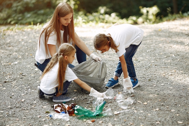 Free photo children collects garbage in garbage bags in park