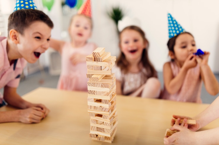 Free Photo children in colored caps laughing on party
