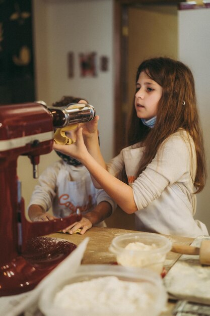 children cook pasta at a gastronomy master class