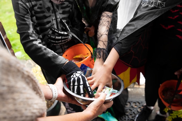 Free photo children in costumes trick or treating on halloween