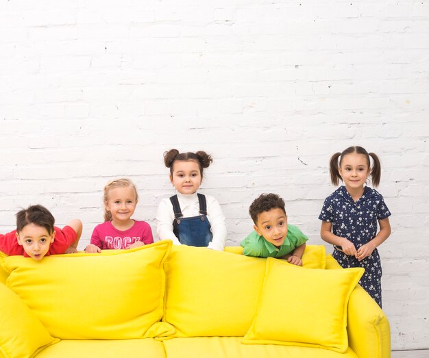 Children group playing in a sofa