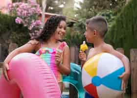 Free photo children having fun with floater by the pool