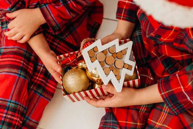 Children holding box of decorations