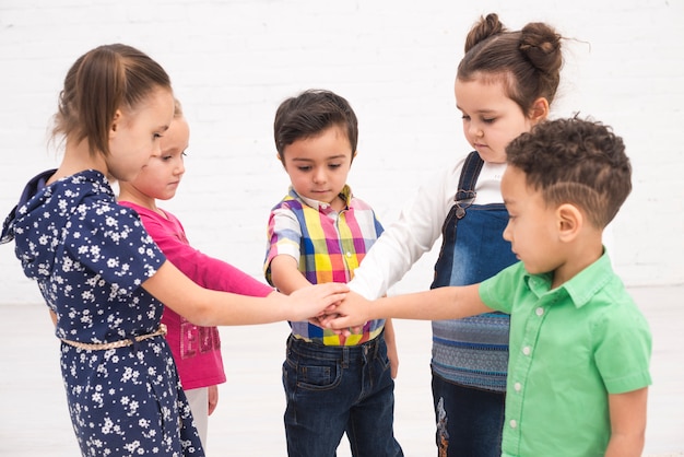 Children holding hand in group