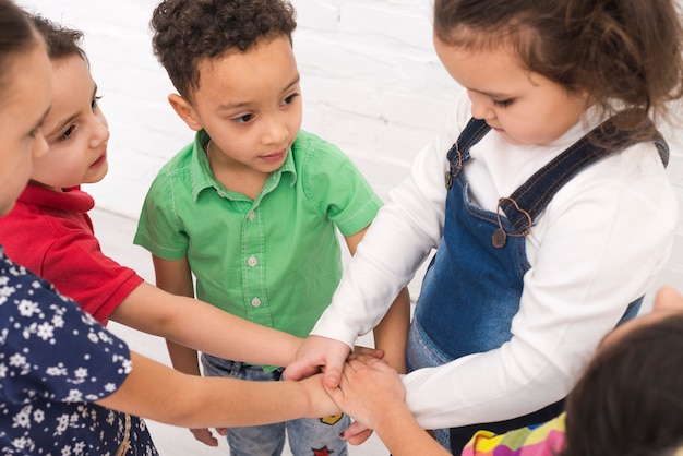 Free photo children holding hand in group