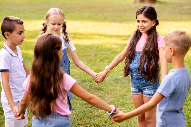 Free photo children holding hands  forms a circle