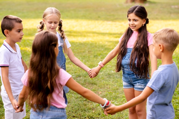 Children holding hands  forms a circle