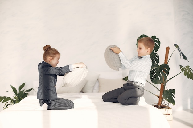 Children at home fight pillows