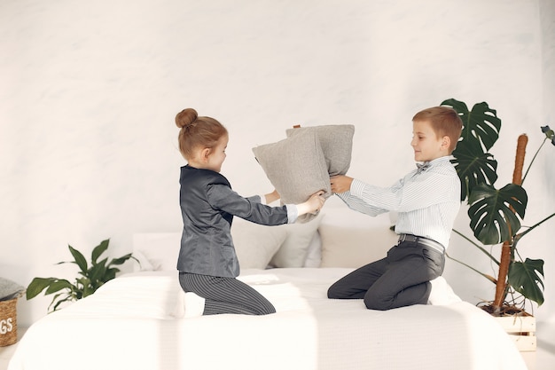 Children at home fight pillows