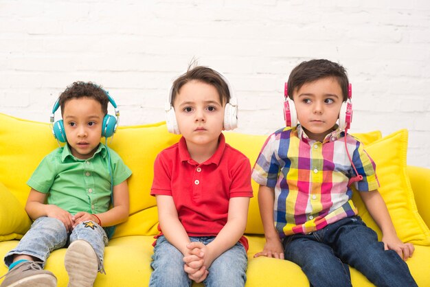 Children listening to music with headphones