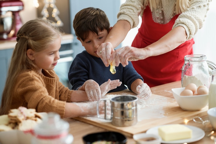 Free Photo children looking at egg cracked by mom