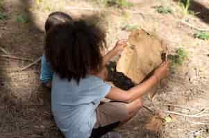 Free photo children participating in a treasure hunt in a forest