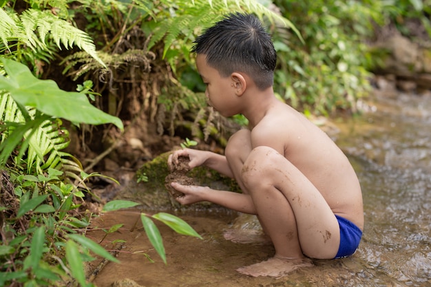 Free photo children play happily in the stream