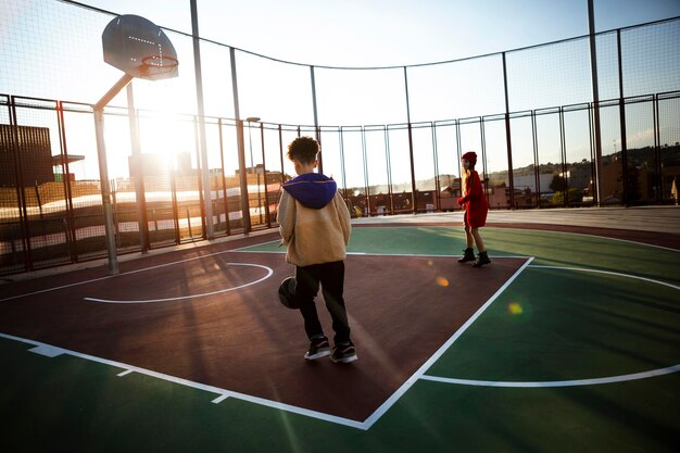 Children playing basketball on a field