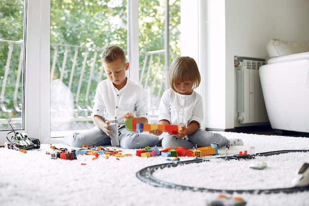 Free photo children playing with lego in a playing room