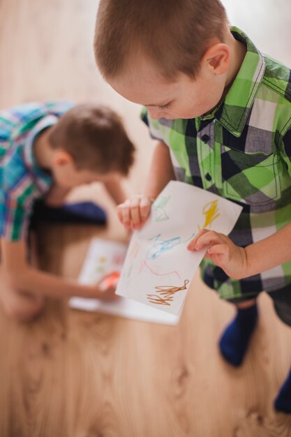 Children preparing drawings for mother's day